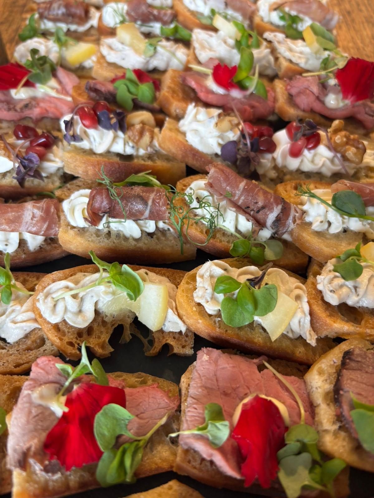 A close-up of filo canapes topped with fig, whipped cheese and caviar.
