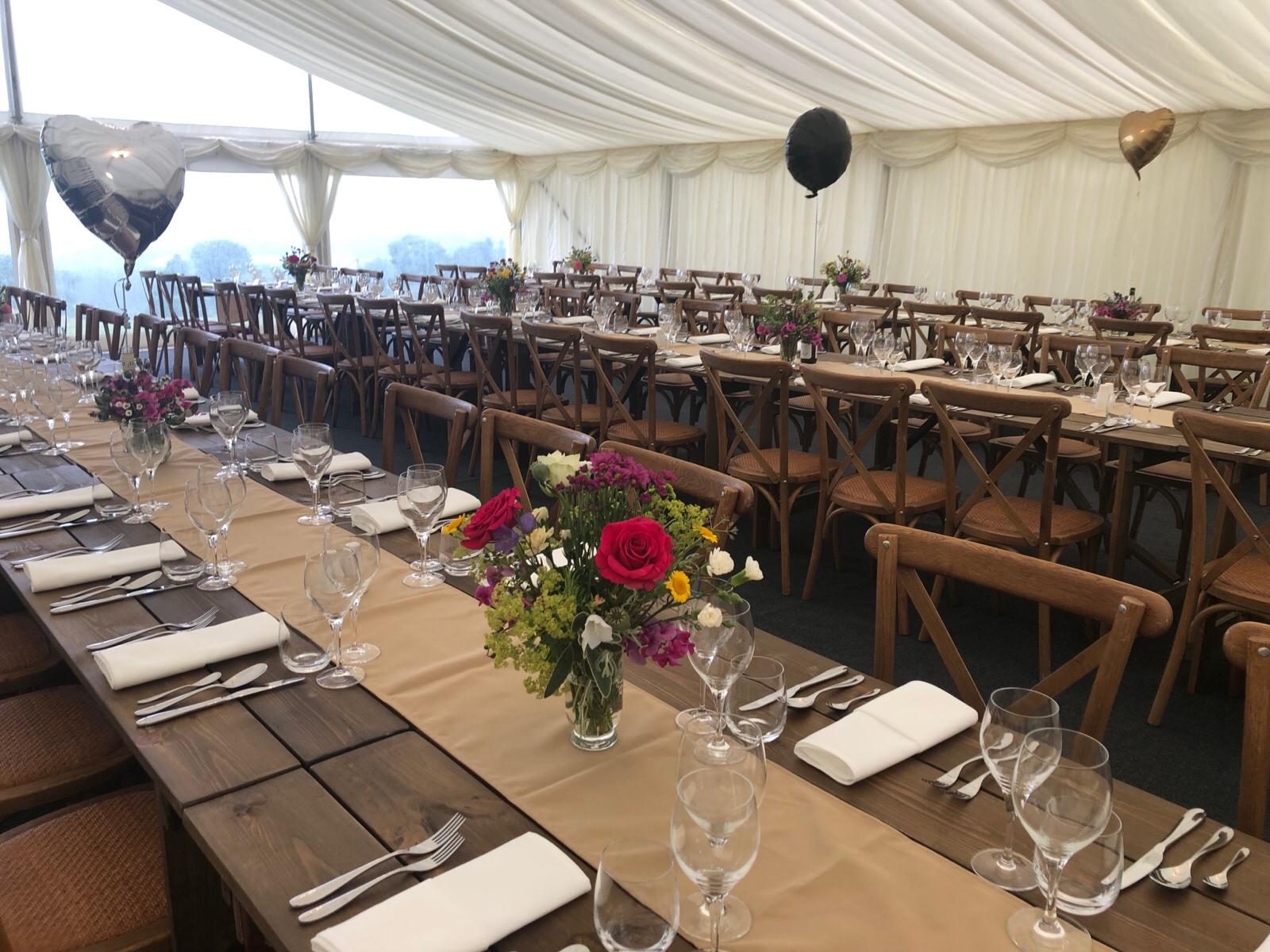 A marquee dressed with balloons and fresh flowers for a private celebration.