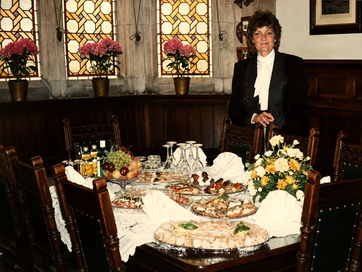 Sally standing beside a laid table set for canapes and drinks service.