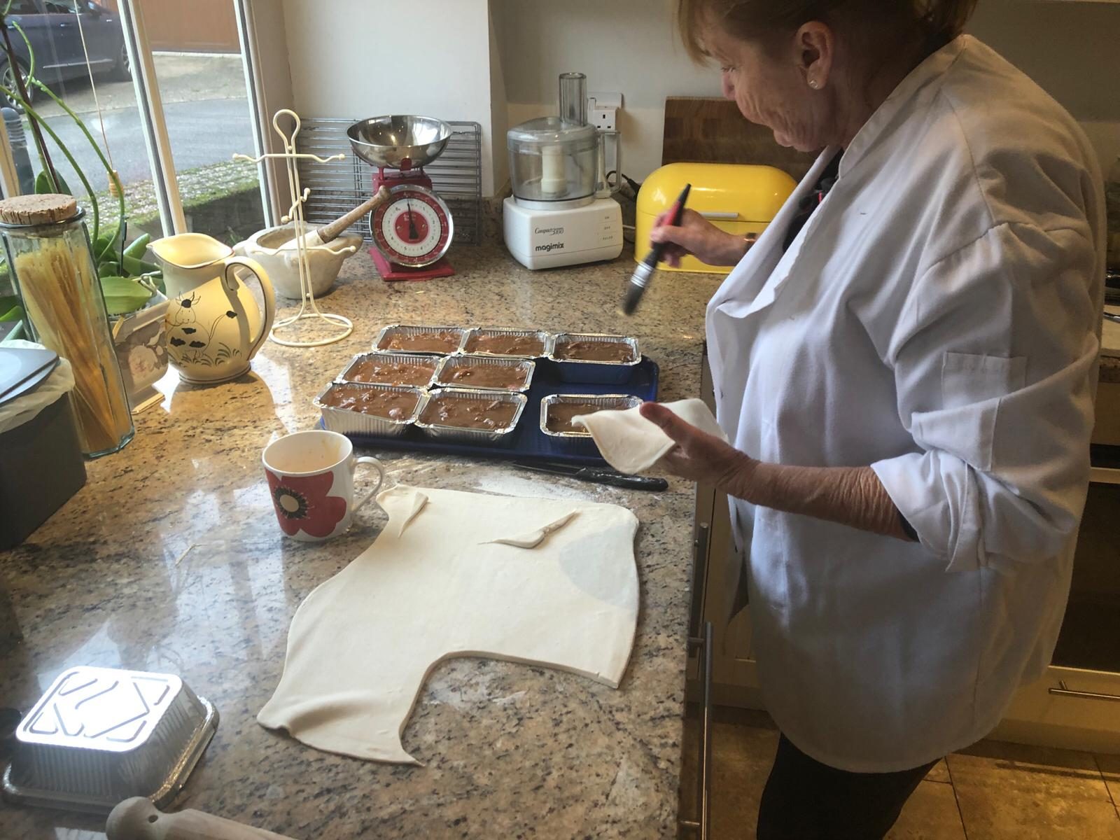Sally preparing a batch of homemade pies in her kitchen.