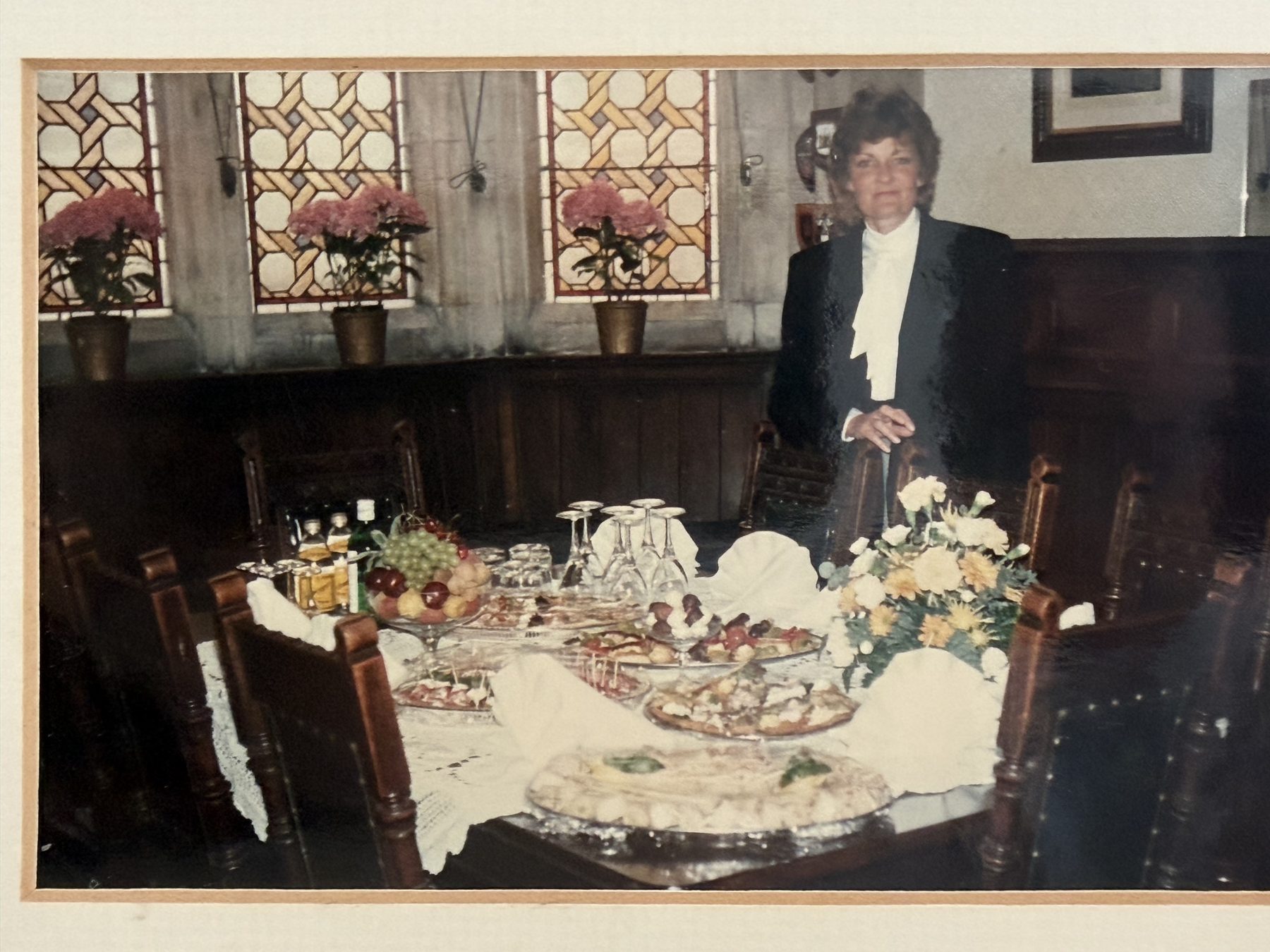 Sally at a laid table, ready to serve, earlier in her career.
